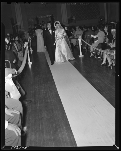 Mr. & Mrs. Jack Pywen; wedding; interior; bride and groom                             walking down isle