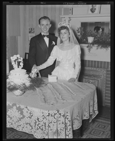 Mr. & Mrs. Tierney; wedding; bride and groom cutting                             wedding cake