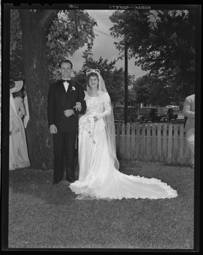 Mr. & Mrs. Tierney; wedding; exterior; bride and groom                             standing next to tree