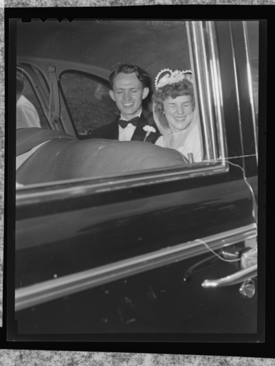 Mr. & Mrs. Tierney; wedding; interior of car; bride and                             groom sitting in back seat