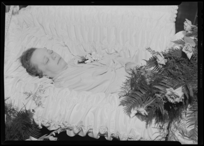 Mrs. C.W. Swallow; corpse; open casket surrounded by                             flowers