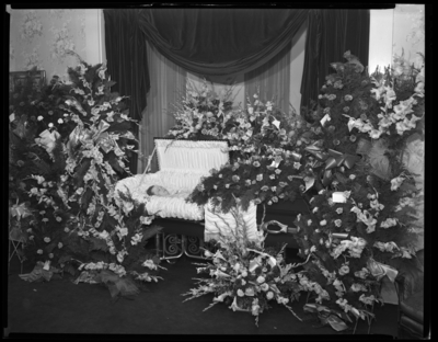 Mrs. C.W. Swallow; corpse; open casket surrounded by                             flowers