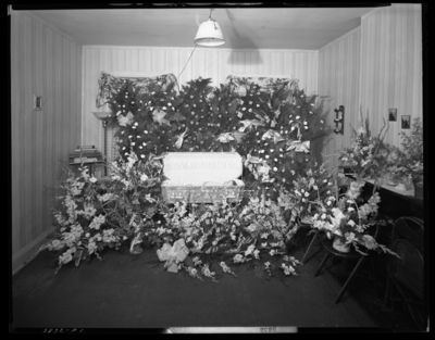 Jackie Hall; corpse of little boy; open casket surrounded by                             flowers
