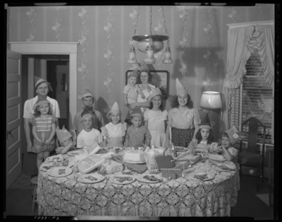 Ann Louise Bourp; birthday party; 424 Transylvania Park;                             interior; group of children gathered around birthday cake on table;                             group portrait