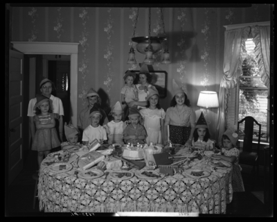 Ann Louise Bourp; birthday party; 424 Transylvania Park;                             interior; group of children gathered around birthday cake on table;                             group portrait