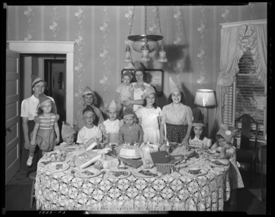 Ann Louise Bourp; birthday party; 424 Transylvania Park;                             interior; group of children gathered around birthday cake on table;                             group portrait