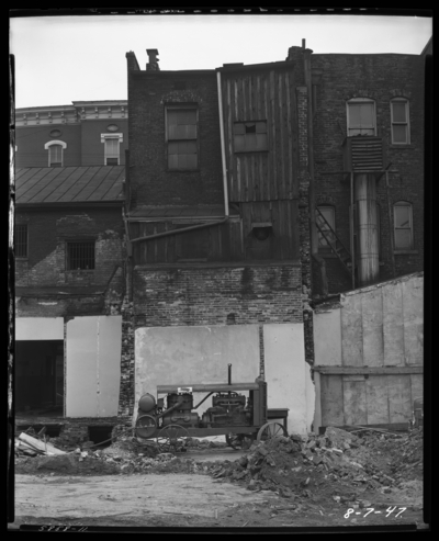 F. W. Woolworth, building being torn down; machine,                             debris