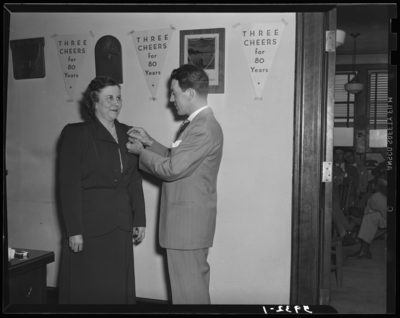 National Life & Accident Insurance Company, 167 West                             Main; First National Bank and Trust Company, 167 West Main; interior;                             woman receiving a pin from a man