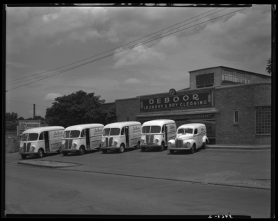 International Harvester Company; De Boor Laundry & Dry                             Cleaning, 265 East Euclid; exterior; dry cleaning delivery trucks parked                             in front of business
