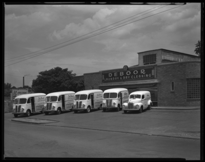 International Harvester Company; De Boor Laundry & Dry                             Cleaning, 265 East Euclid; exterior; dry cleaning delivery trucks parked                             in front of business