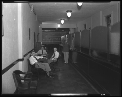 W.E. Hutton & Company, 126 East Main; interior; exchange                             office; men gathered