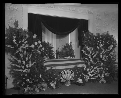 Clinton D. True; corpse; closed casket draped with the American                             Flag surrounded by flowers