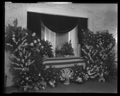 Clinton D. True; corpse; closed casket draped with the American                             Flag surrounded by flowers