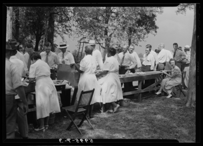 Showalter’s Farm; exterior; Federal Reserve Bankers; group in                             buffet food line around picnic tables