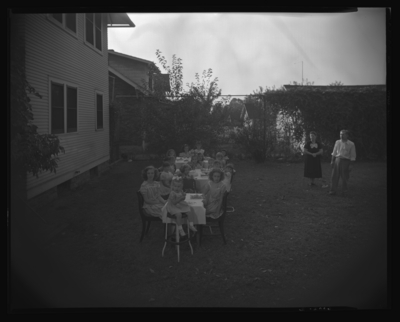 Pollie McGilliard; 299 Forest Park; exterior; birthday party;                             group of children seated at picnic tables