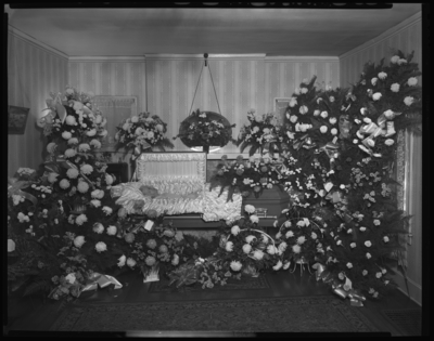 Mrs. Emma S. Gibbons; corpse; open casket surrounded by                             flowers