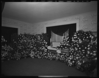 Mallory, Marion G.; corpse; open casket surrounded by                             flowers