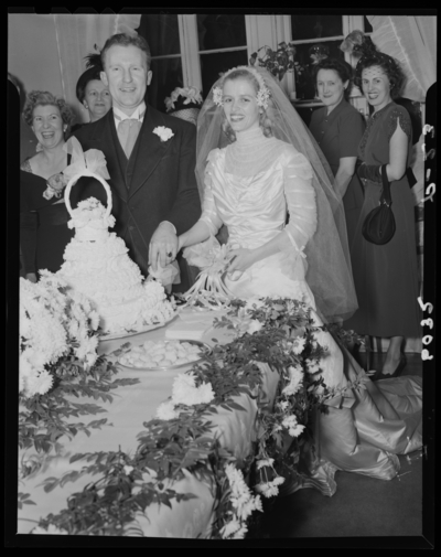 Carojean (Carolyn) Elsey; Wedding; interior; bride and groom                             cutting wedding cake