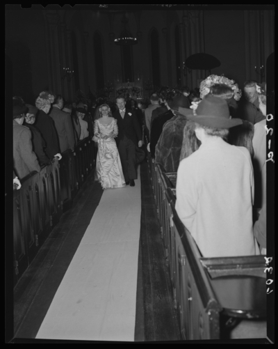 Carojean (Carolyn) Elsey; Wedding; interior; bride and groom                             walking down the isle
