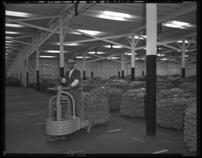Clay Warehouse #1 (Tobacco) (South Broadway); interior; man                             operating a load dispatcher model SD3054; int