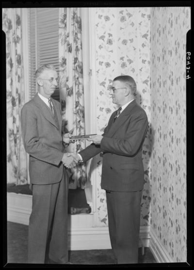 Ewing-VonAlmen Dairy Company, 444 West Fourth (4th); Employee                             Banquet; Dolly Madison Room, Phoenix Hotel; interior; man presenting                             another man with a gift