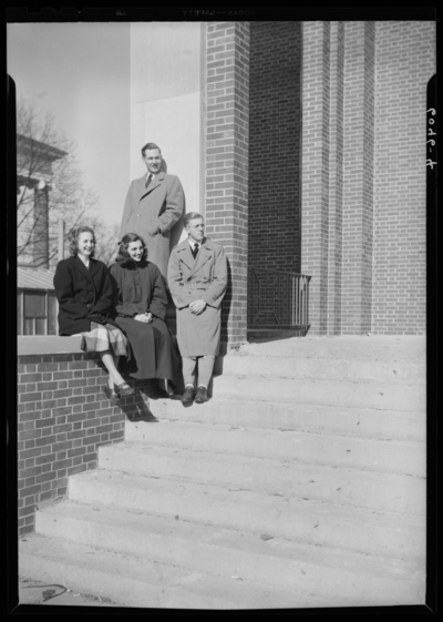 Belle of the Blue; Georgetown College; exterior; group standing                             on steps to building
