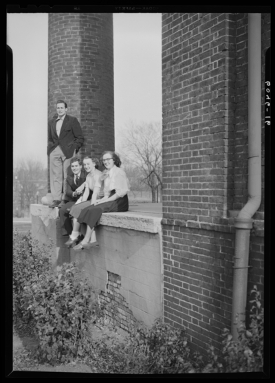 Belle of the Blue; Georgetown College; exterior; group sitting on                             wall of building