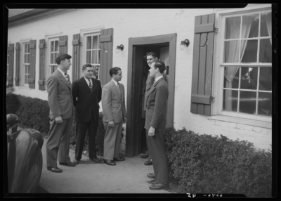 Belle of the Blue; Georgetown College; exterior; group of men                             standing at doorway