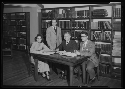 Belle of the Blue; Georgetown College; library; interior; group                             gathered around a table