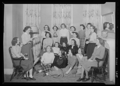 Belle of the Blue; Georgetown College; interior; group of women                             gathered around another woman reading from a book