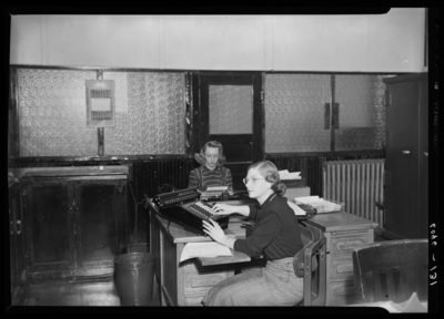 Belle of the Blue; Georgetown College; office; interior; two                             women workers seated at their desks