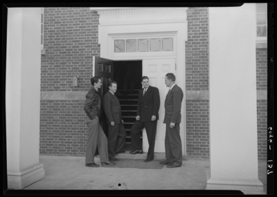 Belle of the Blue; Georgetown College; exterior; group of men                             standing at building entranceway