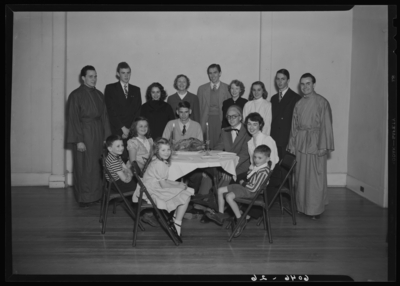 Belle of the Blue; Georgetown College; interior; group gathered                             around a small table, children seated at table, cooked turkey on a                             platter