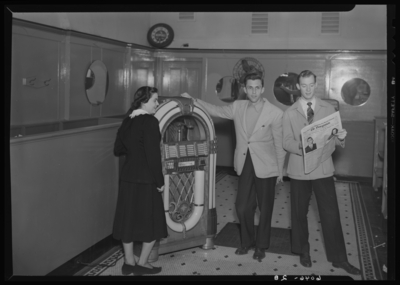 Belle of the Blue; Georgetown College; interior; group standing                             next to a jukebox