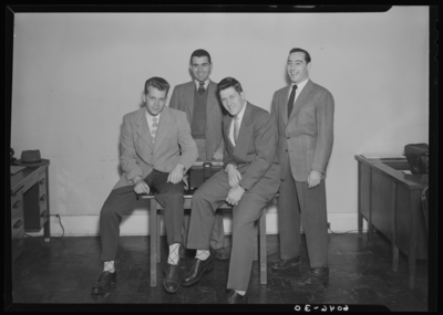 Belle of the Blue; Georgetown College; interior, four men                             gathered around a table with typewriter; group portrait