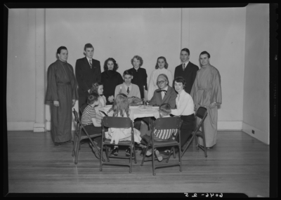 Belle of the Blue; Georgetown College; interior; group gathered                             around a small table, children seated at table, cooked turkey on a                             platter