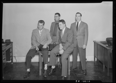 Belle of the Blue; Georgetown College; interior, four men                             gathered around a table with typewriter; group portrait