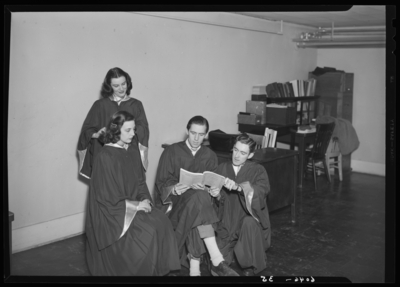 Belle of the Blue; Georgetown College; group (graduates) gathered                             around a student with a book