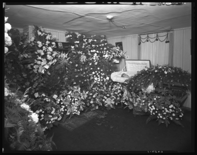 Mrs. Thomas Sutton; corpse; open casket surrounded by                             flowers