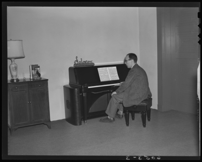 Shackleton’s Music Store Incorporated; 147 East Main; interior;                             man sitting at a piano display for Solovox