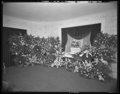 Chas P. Perkins; corpse; open casket surrounded by                             flowers