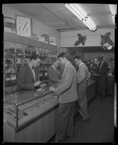 Jay's Jewelry store, 116 1/2 South Limestone; interior;                             salesman attending to customers at display counter