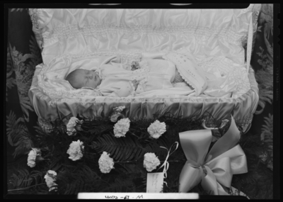 Stephen Earl White; corpse, baby; open casket surrounded by                             flowers