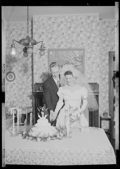 Swindler, Mr. & Mrs.; wedding; interior; bride and groom                             cutting wedding cake