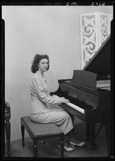 Mrs. J.B. Brookshire (Raymondville, Missouri); interior; woman                             sitting at piano