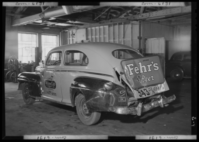 Lexington Yellow Cab, 150 North Limestone; interior; wrecked                             (damaged) cab (car); driver side and rear view; advertisement for                             Fehr's Beer on truck of cab