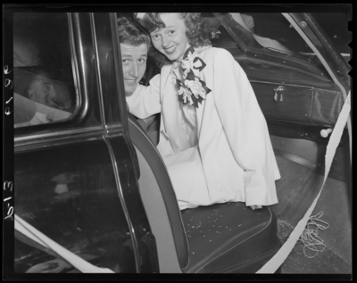 Mr. & Mrs. Guy Preston Richardson; wedding; interior of                             car; bride and groom looking out passenger side door