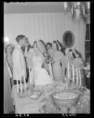Mr. & Mrs. Guy Preston Richardson; wedding; interior;                             bride feeding groom wedding cake