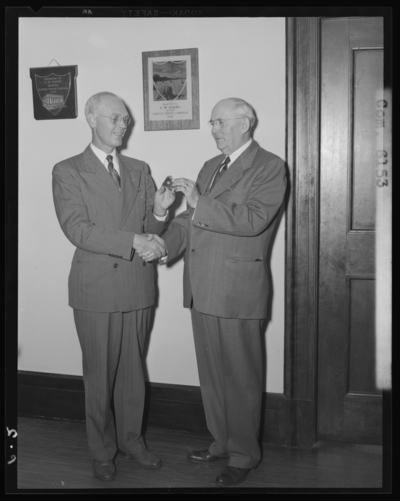National Life & Accident Insurance Company, 167 West                             Main; interior; presentation of pin; two men shaking hands
