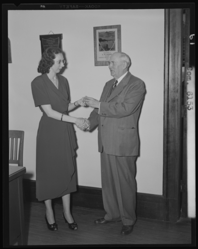 National Life & Accident Insurance Company, 167 West                             Main; interior; presentation of pin; man and woman shaking                             hands